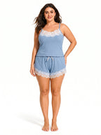 Woman wearing a light blue ribbed knit camisole and shorts set with white lace trim.