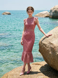 Model posing by the sea in Dusty Rose Lace Midi Dress
