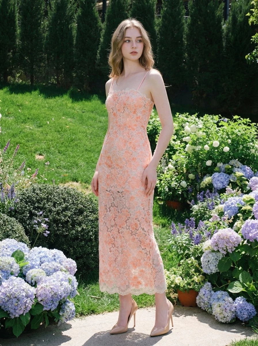 woman wearing a peach floral lace sheath dress standing in a garden with hydrangeas
