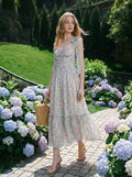 Woman in a floral print midi dress walking in a garden