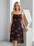 Woman posing in a black floral print midi dress with spaghetti straps and a flowing skirt