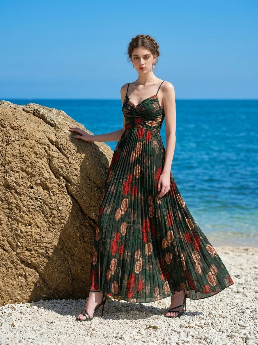 Woman in a dark green floral print maxi dress posing on a sandy beach