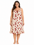 Model wearing a cream and red floral print nightgown with ruffled straps and hem.