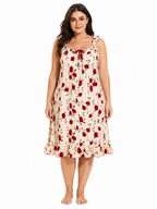 Model wearing a cream and red floral print nightgown with ruffled straps and hem.