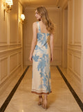 Back view of a woman in a sleeveless floral print midi dress.