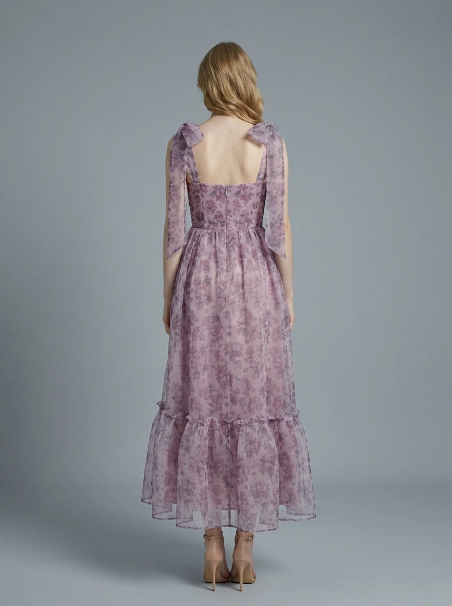 Back view of a floral print A-line dress with tiered hem