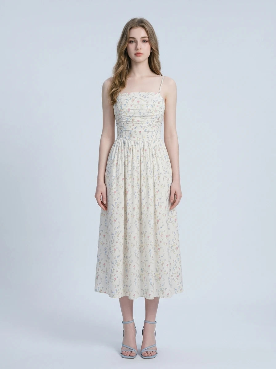 Woman wearing a floral print midi dress with spaghetti straps and a square neckline.