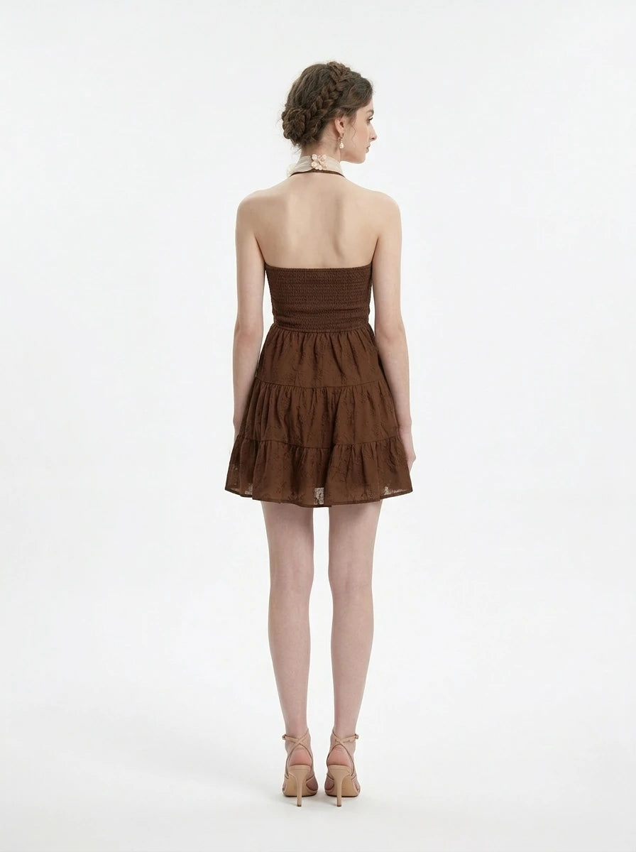 Woman wearing a brown halter neck tiered mini dress