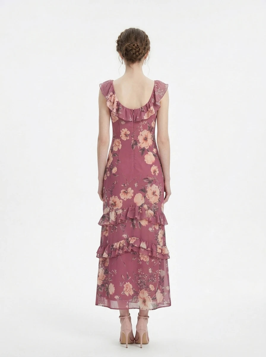Woman wearing a floral print chiffon maxi dress with ruffled neckline and tiered skirt