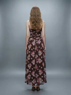 Back view of a woman in a strapless floral print chiffon maxi dress
