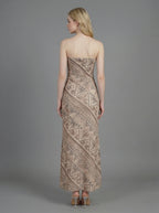 Back view of a woman in a strapless geometric print maxi dress