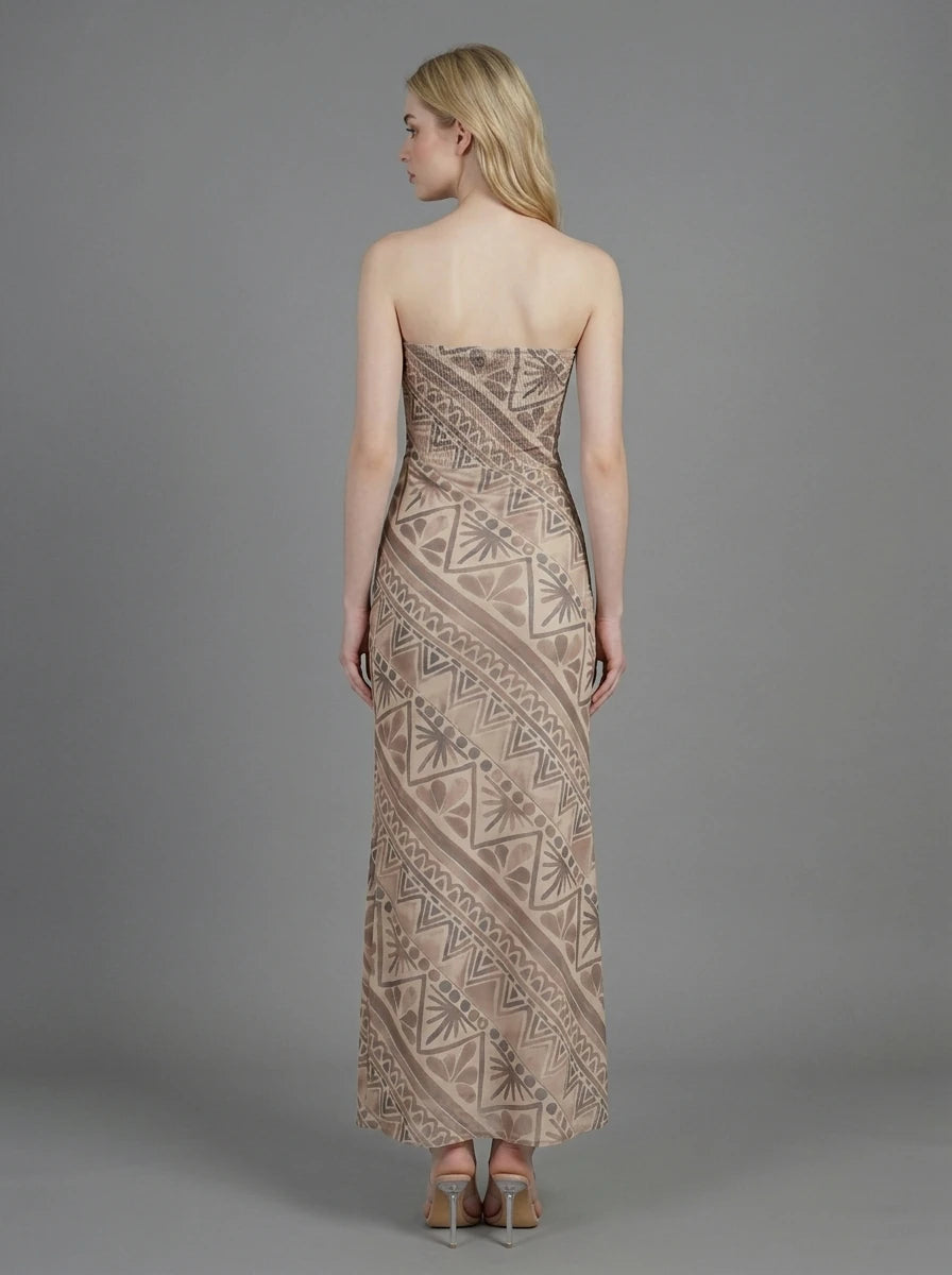 Back view of a woman in a strapless geometric print maxi dress