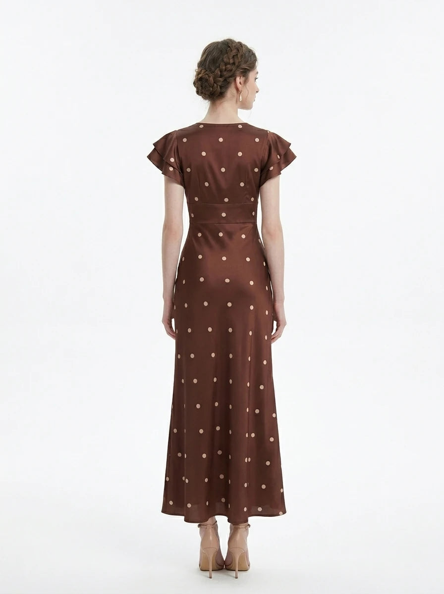 Model wearing a brown polka dot midi dress with a v-neckline and ruffled sleeves.