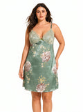 Woman wearing a green satin slip dress with a floral print and lace trim