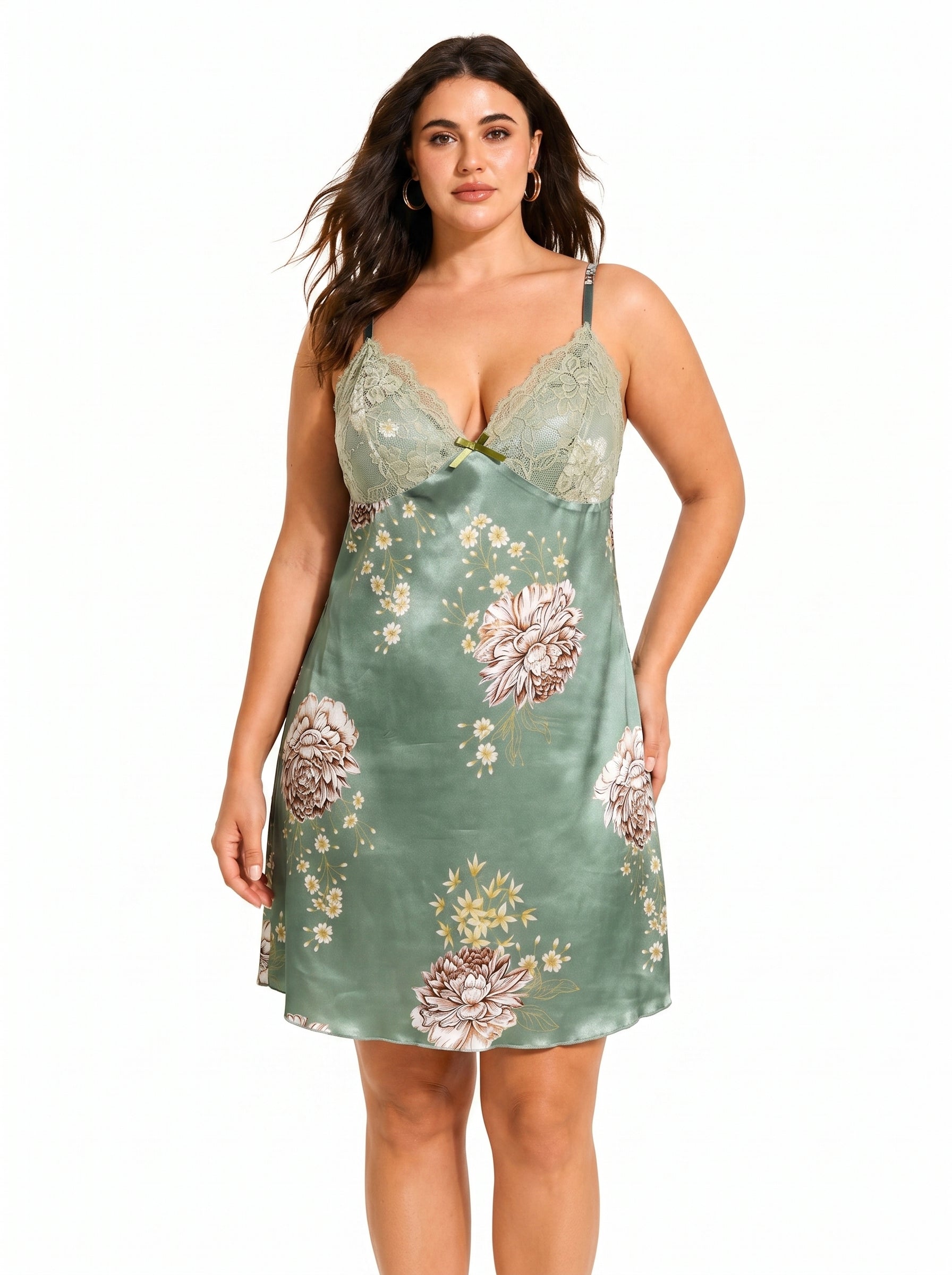 Woman wearing a green satin slip dress with a floral print and lace trim