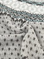 Close-up of the textured knit fabric of a grey sweater with a Fair Isle pattern