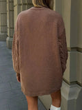 Back view of a woman in a brown cable knit sweater dress