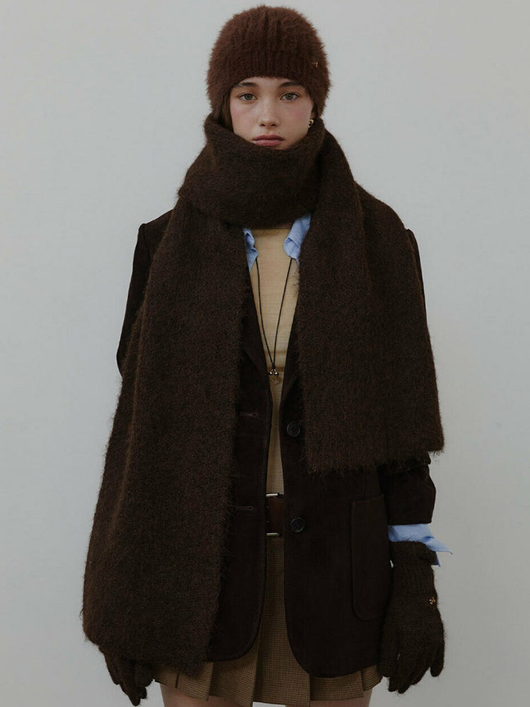 Model wearing a brown knit scarf and matching beanie