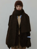 Model wearing a brown knit scarf and matching beanie