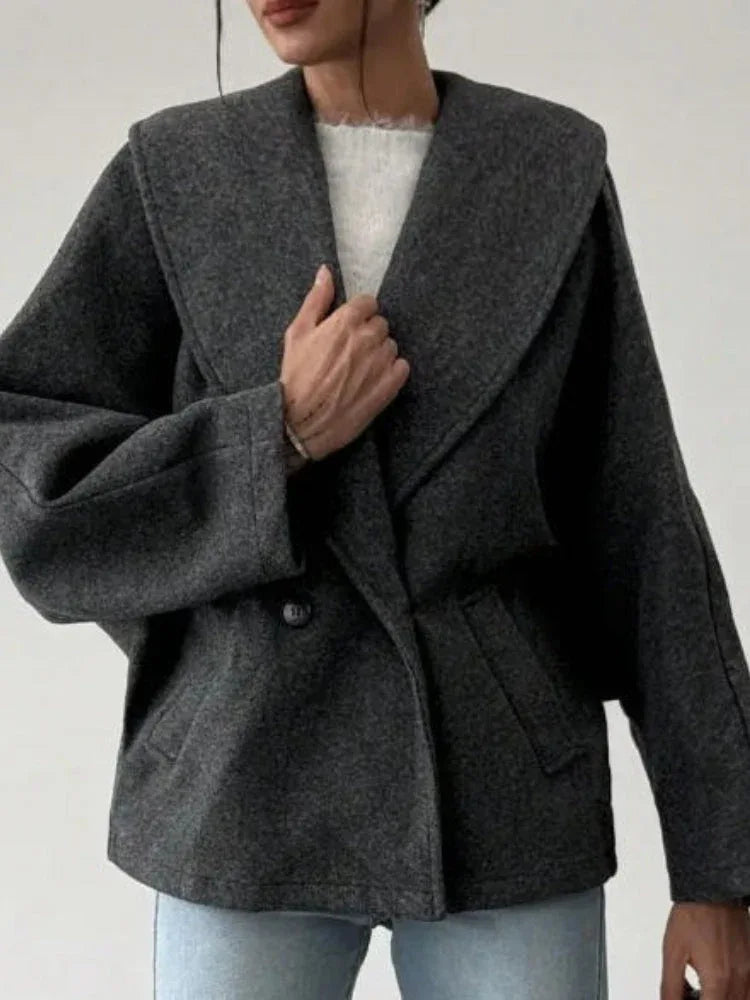 Close-up of the lapel and collar detail on a grey wool blend coat.