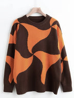 A brown and orange abstract patterned knit sweater on a hanger against a white background.