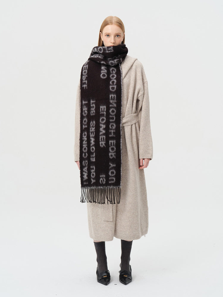 Full body view of a woman in a beige cardigan and black scarf with text