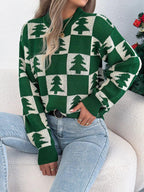 Woman wearing a green and white checkerboard Christmas tree knit sweater
