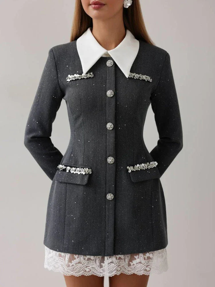 Woman wearing a grey tweed-inspired mini dress with a white collar and crystal buttons