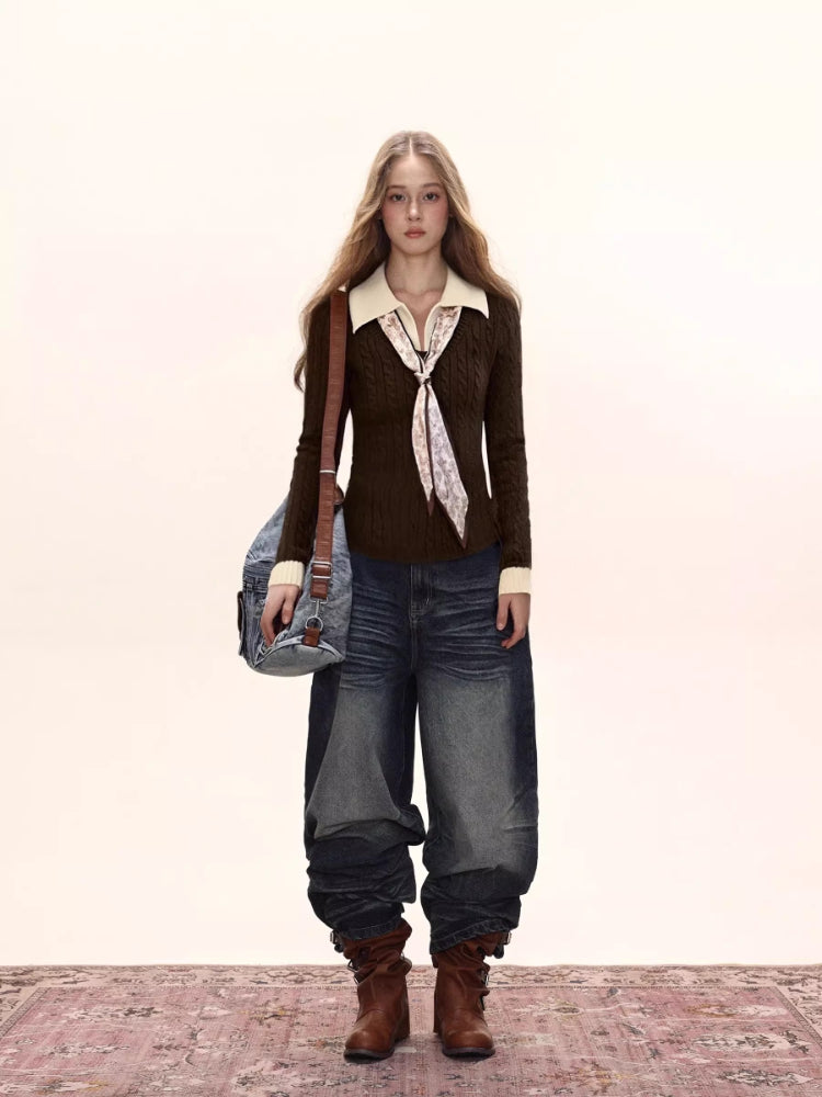 Full body shot of a woman in a brown cable knit sweater, white collar and cuffs, dark wash wide-leg jeans, and brown boots.