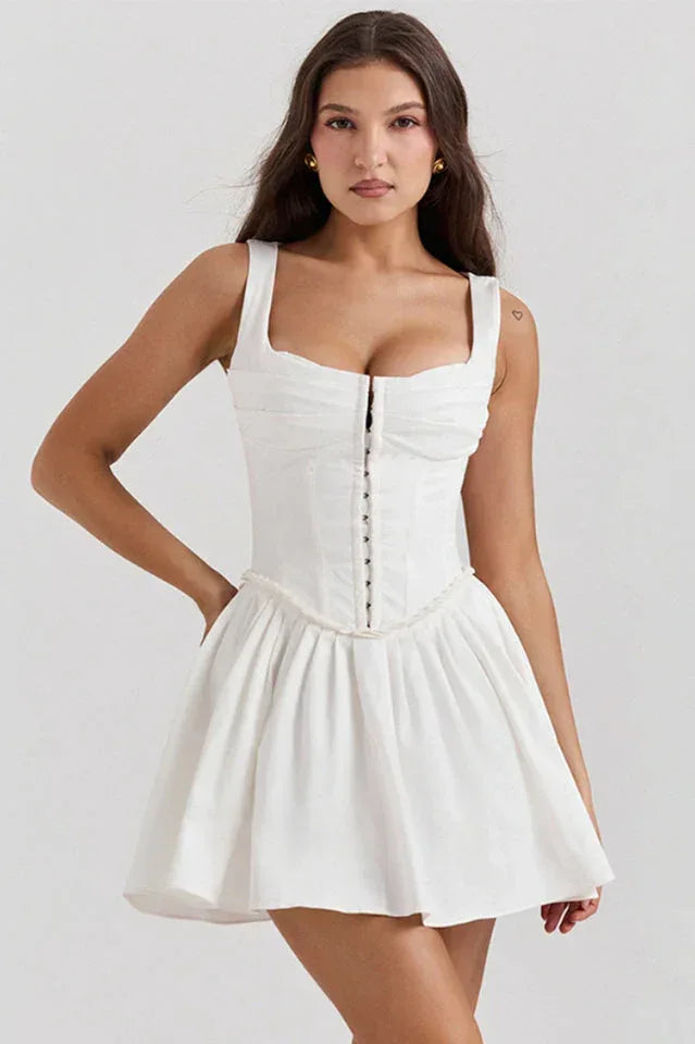 Woman wearing a white sleeveless corset dress with a gathered skirt Main image