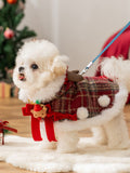 White dog wearing a red plaid pet coat with a leash attached, showcasing holiday design