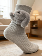 Gray crew socks with a 3D fluffy bunny applique on the ankle, featuring a ribbed texture and non-slip grips on the sole.