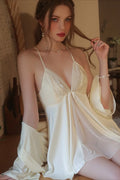 Close-up of a woman in a cream satin chemise and robe, showing the lace bust detail.