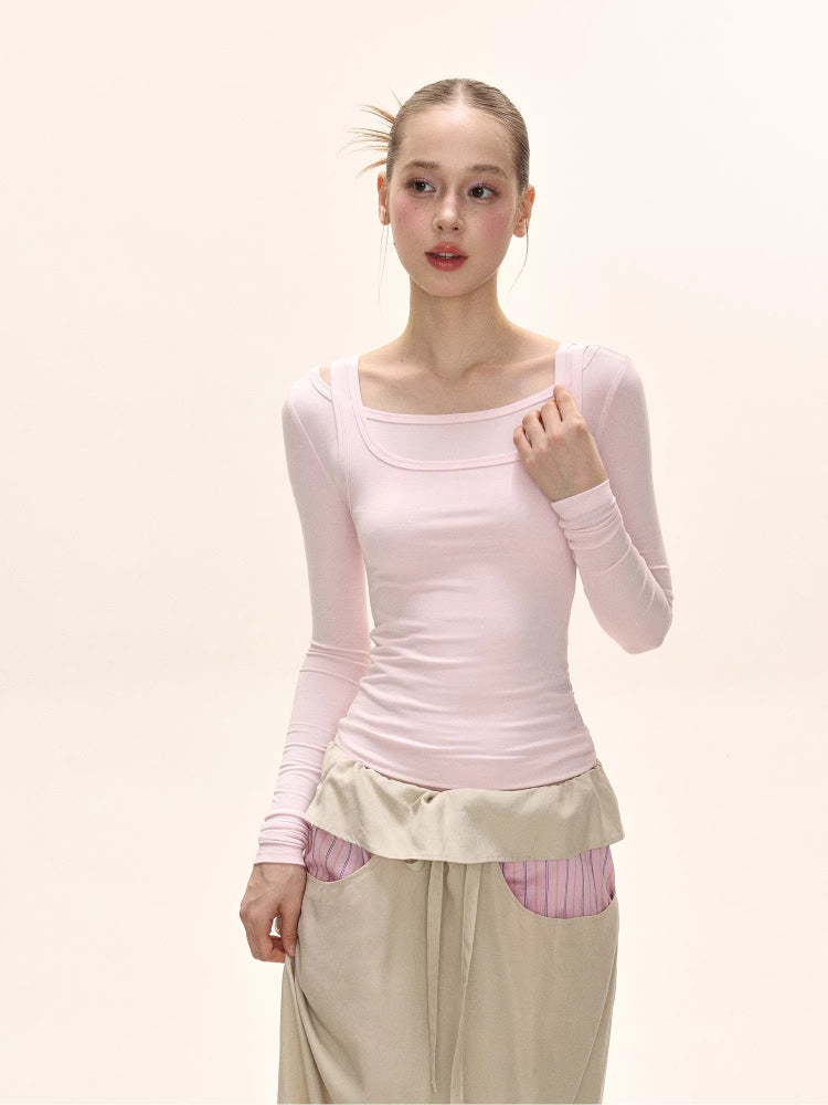 Model wearing a light pink long-sleeve fitted top with a square neckline.