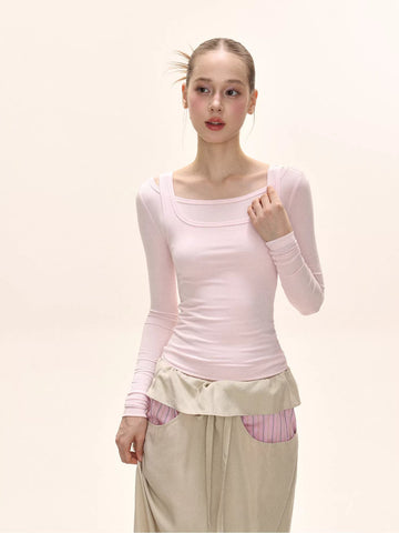 Model wearing a light pink long-sleeve fitted top with a square neckline.