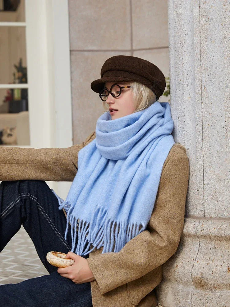 woman sitting and wearing a light blue scarf