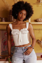White satin corset top with ruching and bow detail