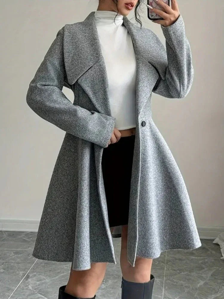 Woman showing off the open front of a grey fit-and-flare wool blend tweed coat.