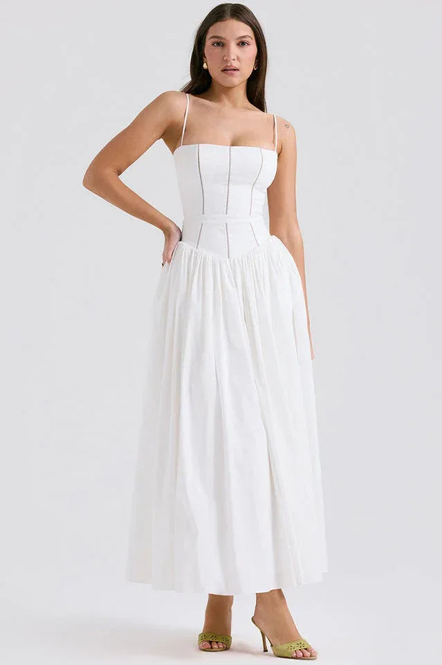 Woman wearing a white cotton poplin square neck maxi dress with spaghetti straps and a full A-line skirt. Main image