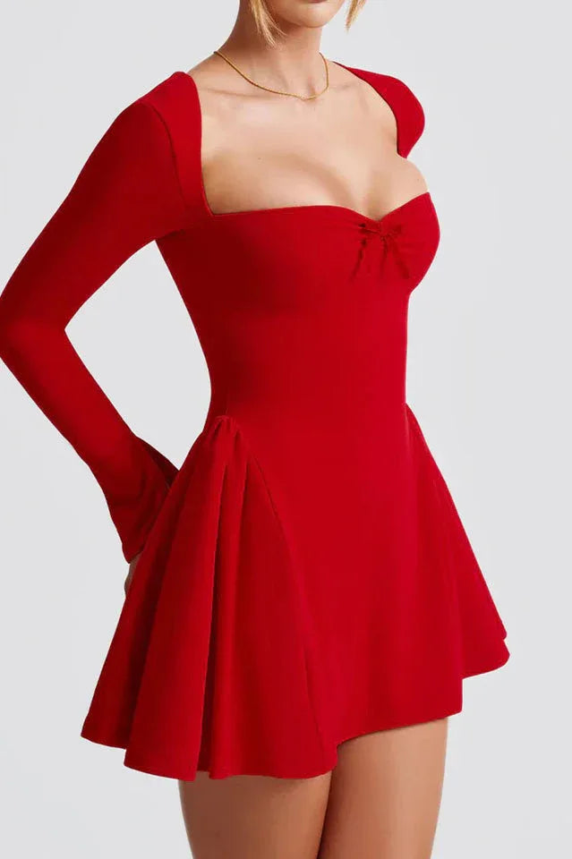 Side view of a red fit and flare dress with long sleeves