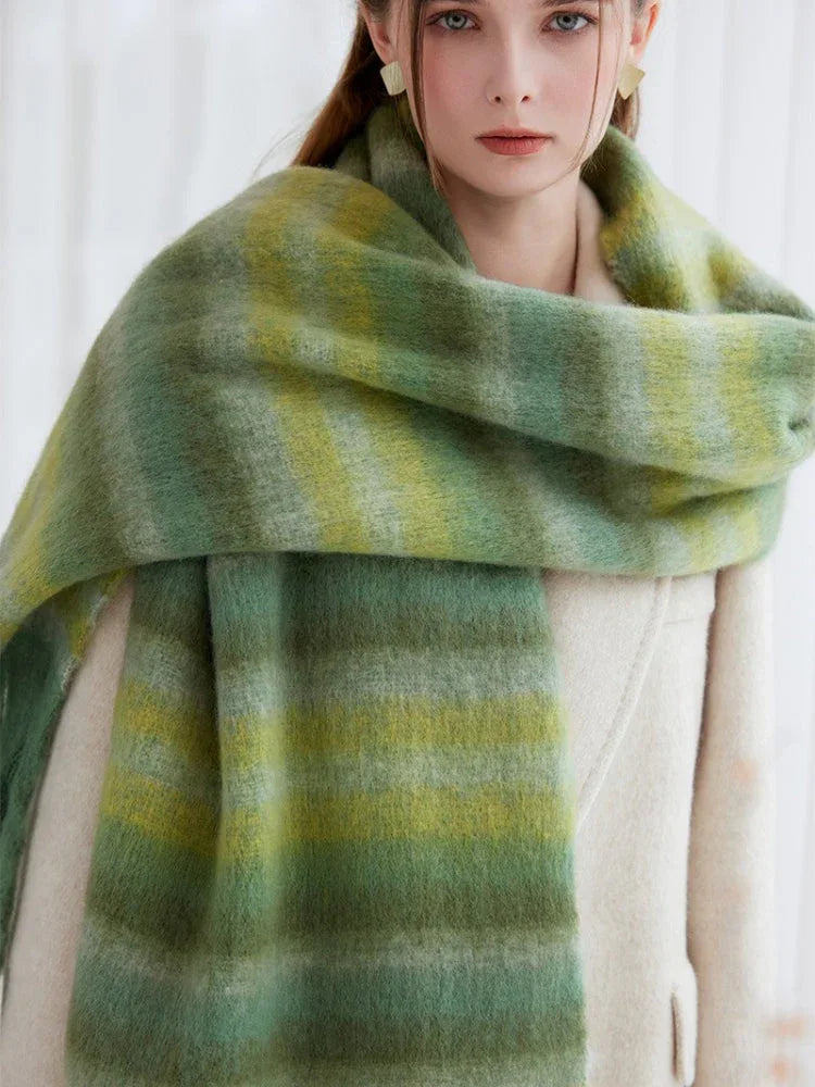 Close-up of a woman's face and shoulders showing a fuzzy green striped scarf