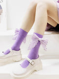 Purple ankle socks with decorative bows featuring pearl-like accents.