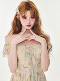 Close-up of a cream floral print chiffon mini dress with ruffle trim and a tie-front detail.