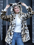 Woman wearing a leopard print faux fur hooded jacket with ears