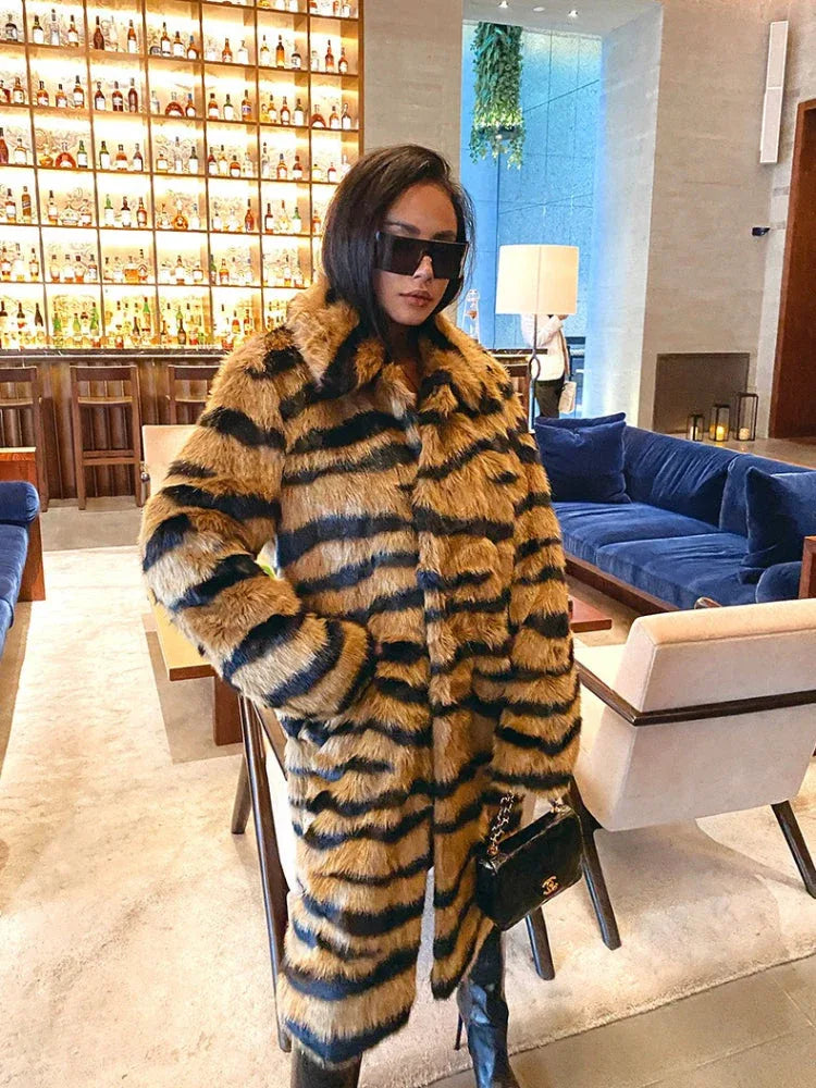 Woman wearing a faux fur tiger stripe coat inside a lounge.