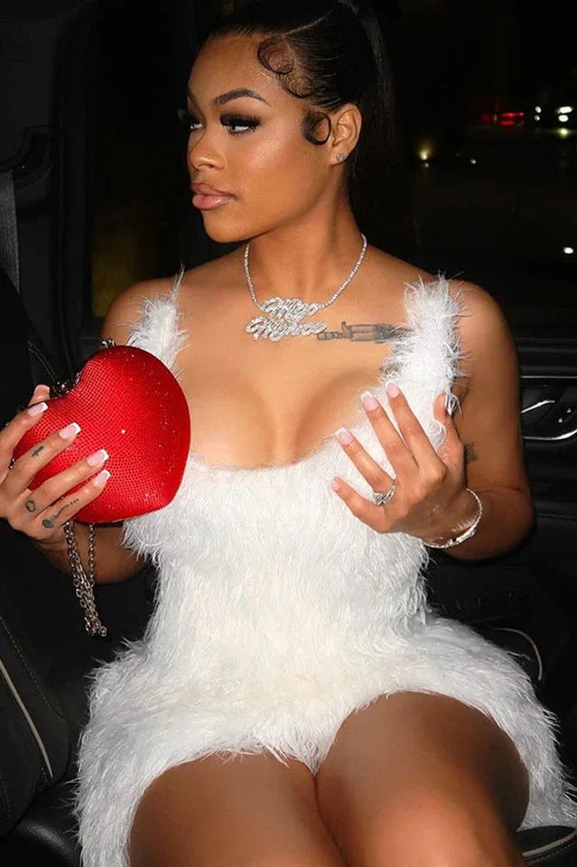 Close-up of a woman in a white feather trim dress