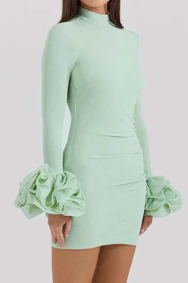 Mint green bodycon mini dress with long sleeves and ruffled cuffs, side view