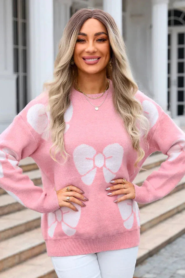 front view of a woman in a pink bow print sweater
