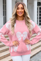 front view of a woman in a pink bow print sweater