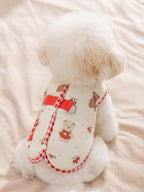 Back view of a cream-colored dog vest with teddy bear and floral print, showing red gingham trim and D-rings.